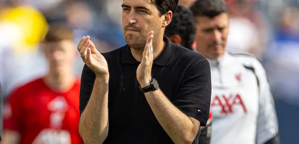 Coach applauding during a match at the stadium