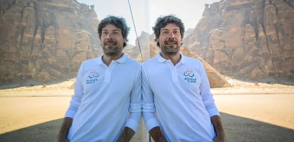 Man posing in desert with mountains in background