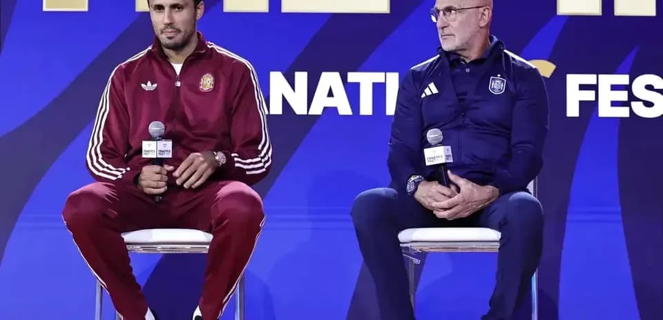 Coaches seated at press conference with microphones