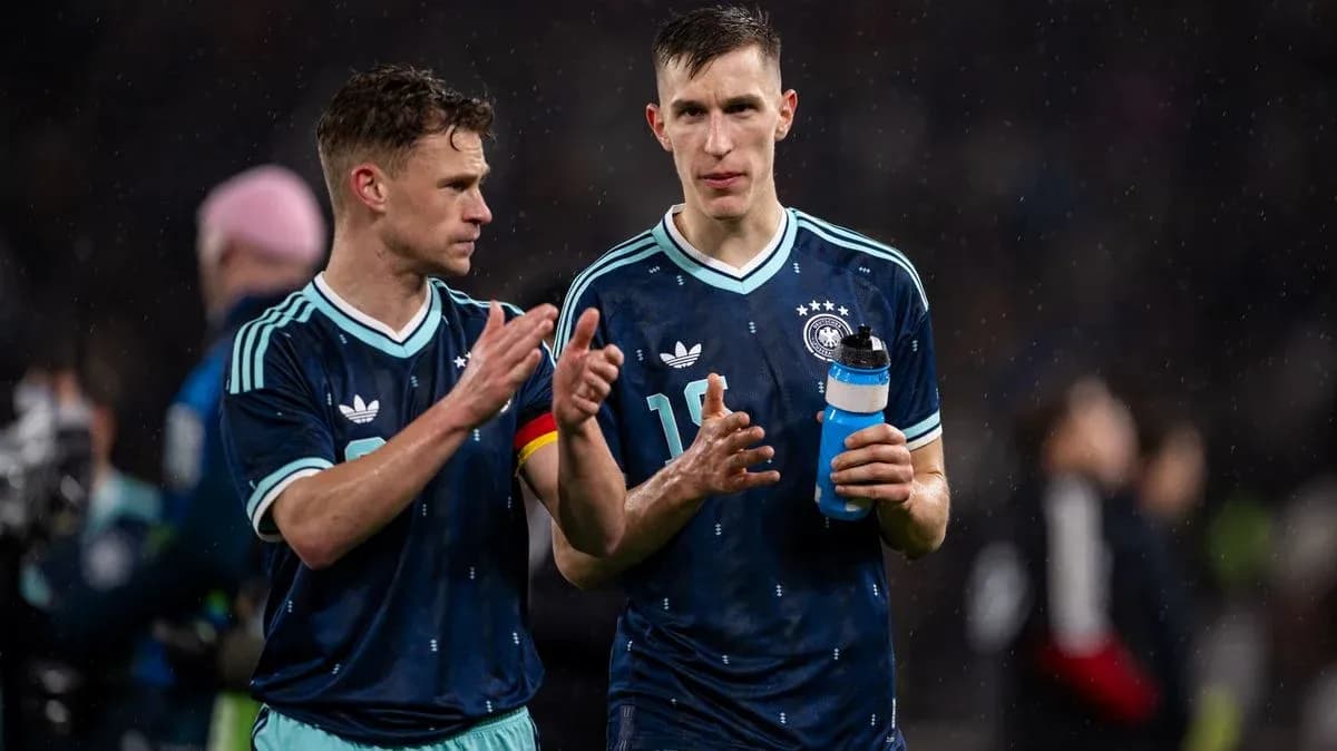 Two German players walking off the pitch post-match