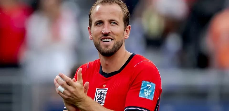 Player applauding in red England jersey on field
