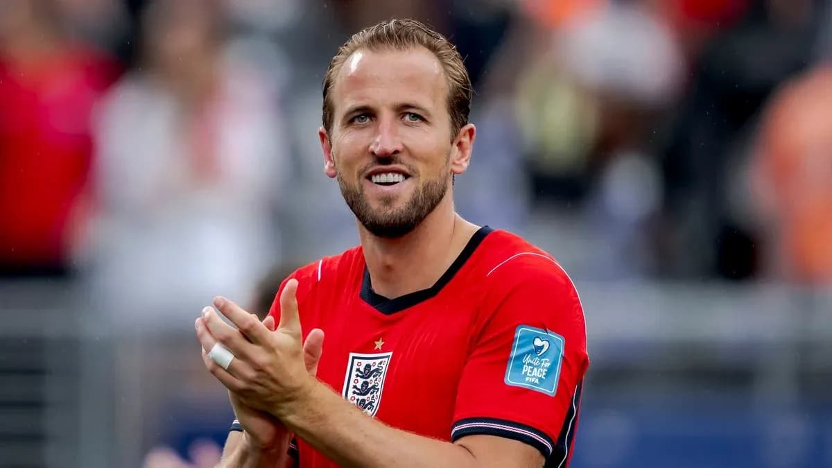 Player applauding in red England jersey on field