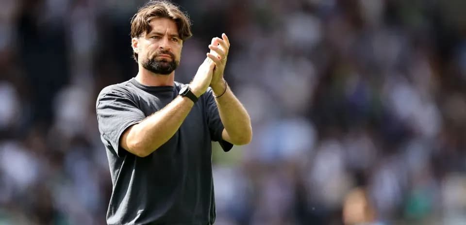Coach applauding fans after the match