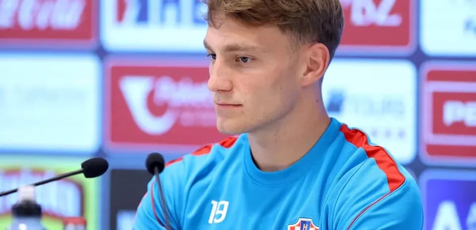 Player at press conference wearing Croatian national team kit