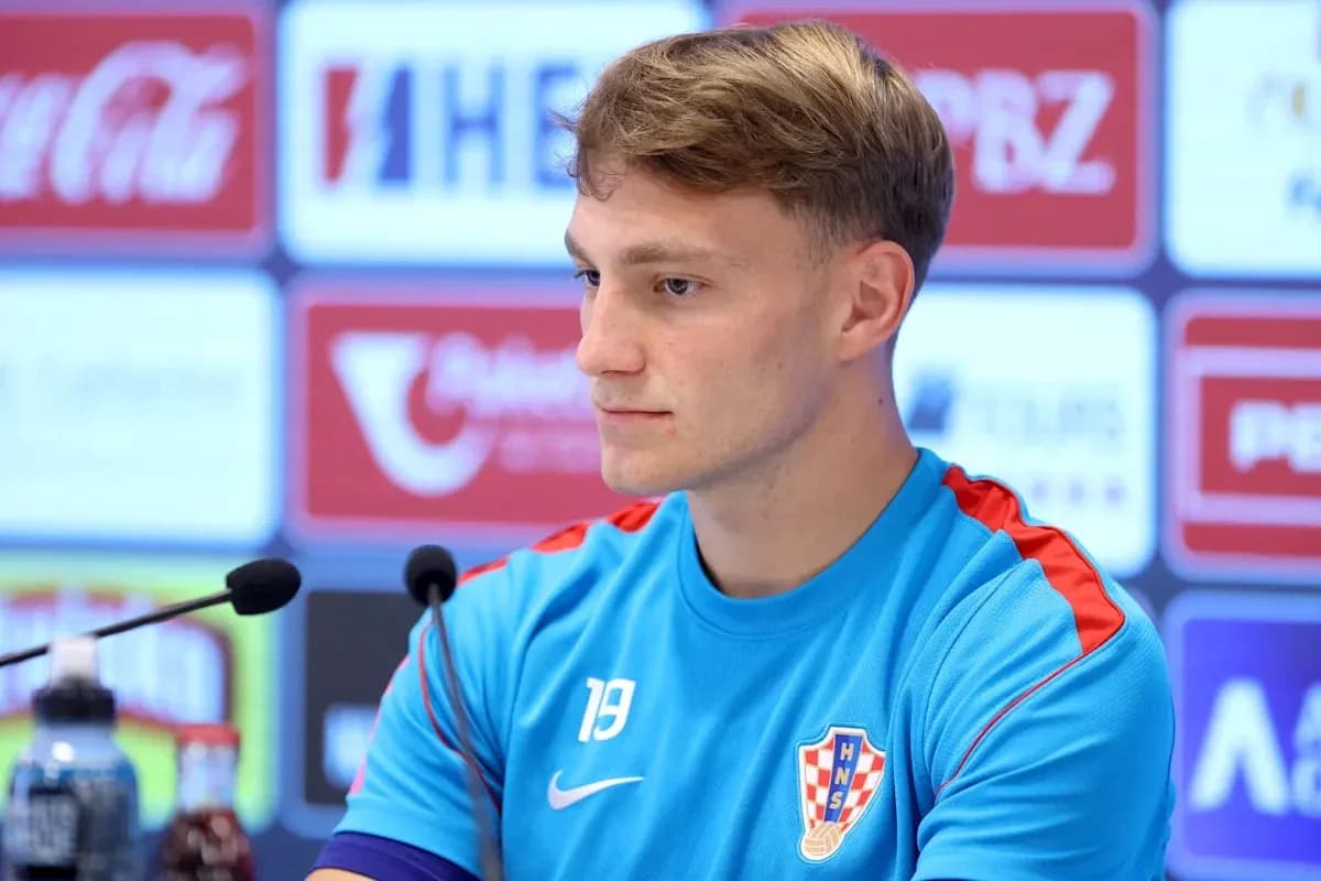 Player at press conference wearing Croatian national team kit