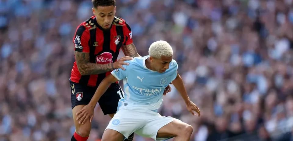 Player from Bournemouth tackling Manchester City player
