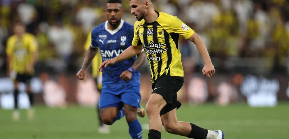Player in yellow dribbling the ball during match