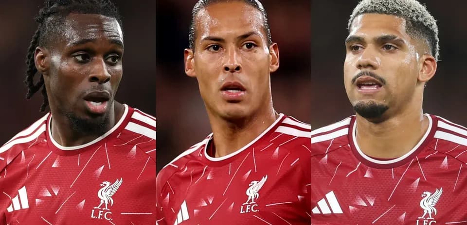 Three Liverpool FC players in red kits during match
