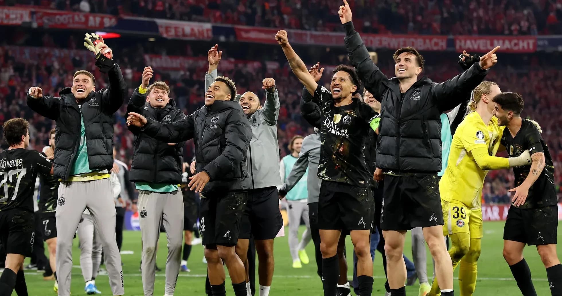 Players celebrating victory on the pitch after match