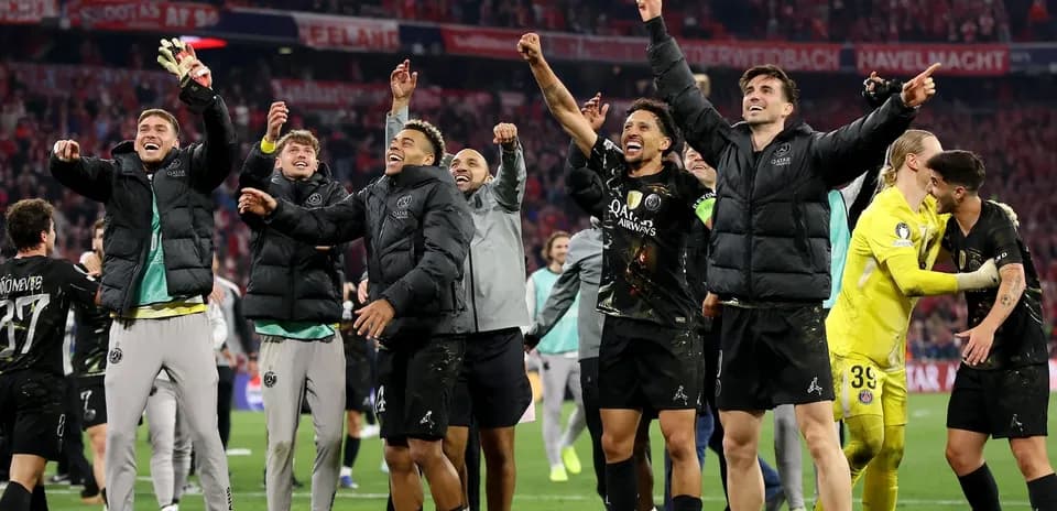 Players celebrating victory on the pitch after match