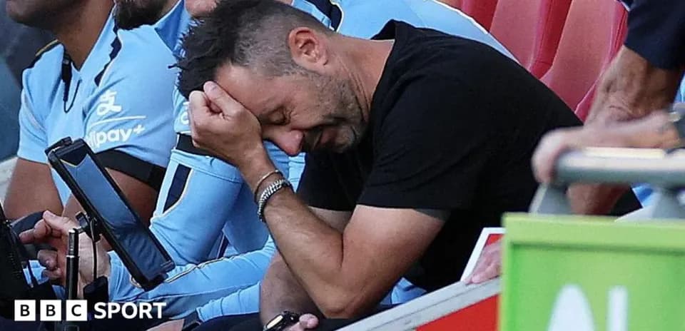 Coach with head in hand on the sidelines