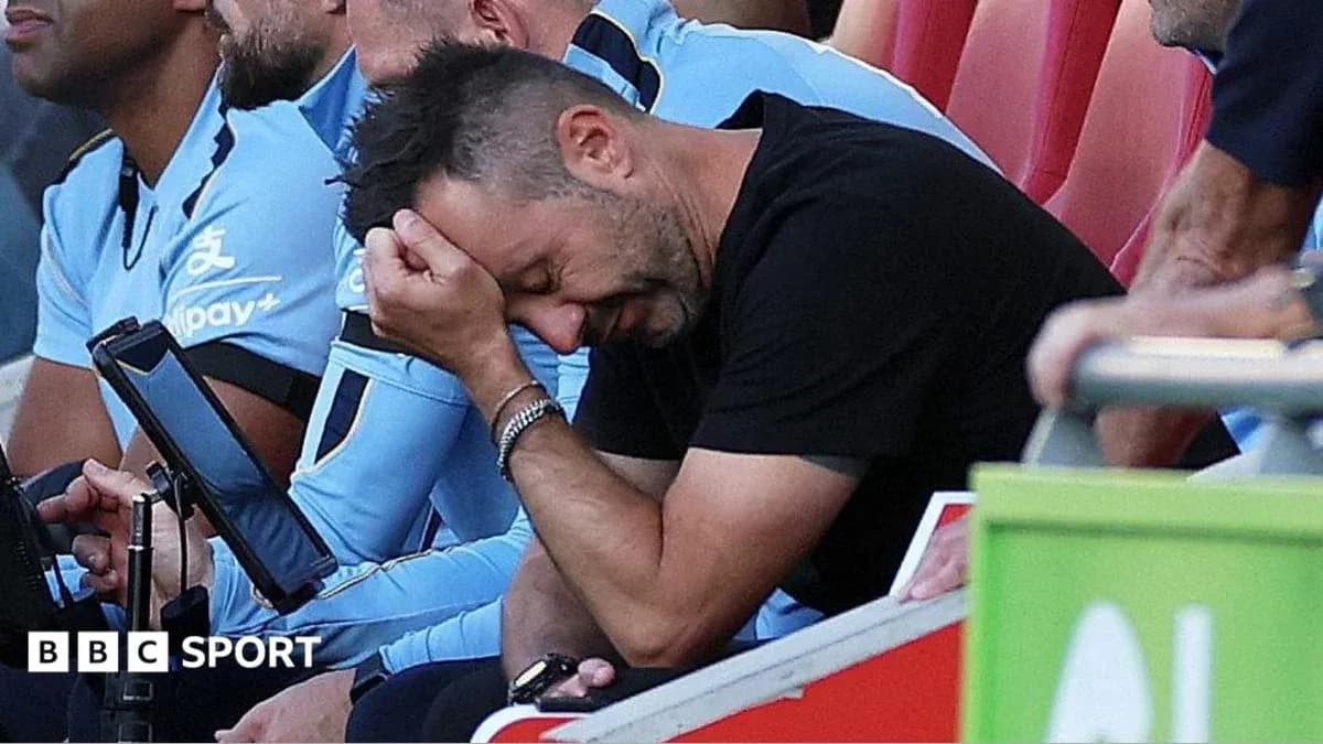 Coach with head in hand on the sidelines