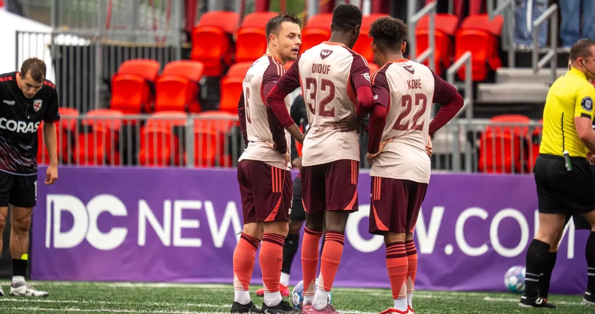 Detroit City players discussing strategy during match