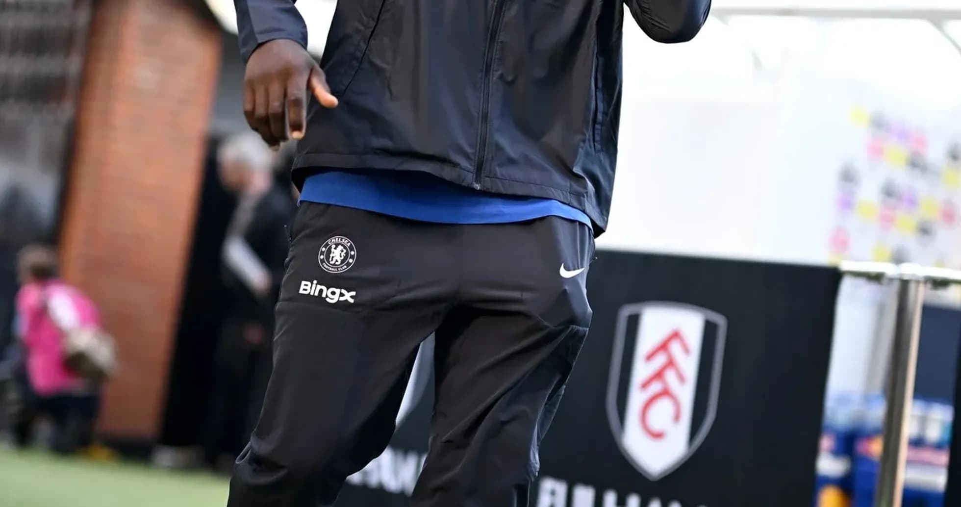 Player arriving at stadium in team tracksuit