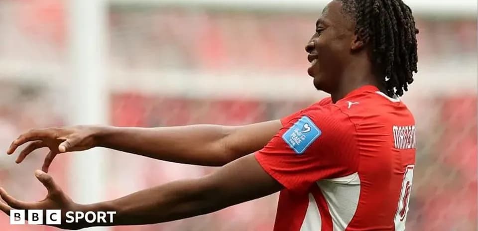 Player celebrating with arms outstretched on field