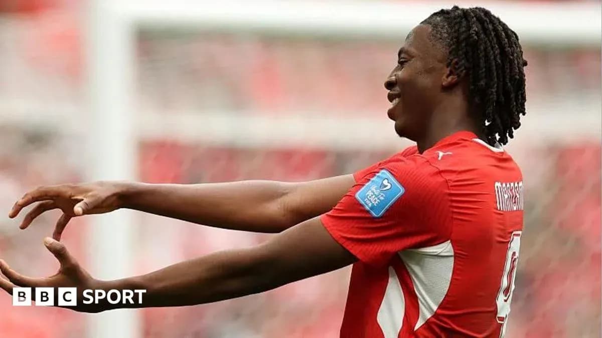 Player celebrating with arms outstretched on field