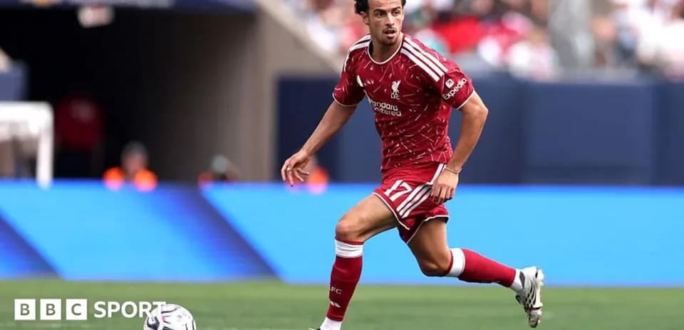 Player in red kit running with the ball