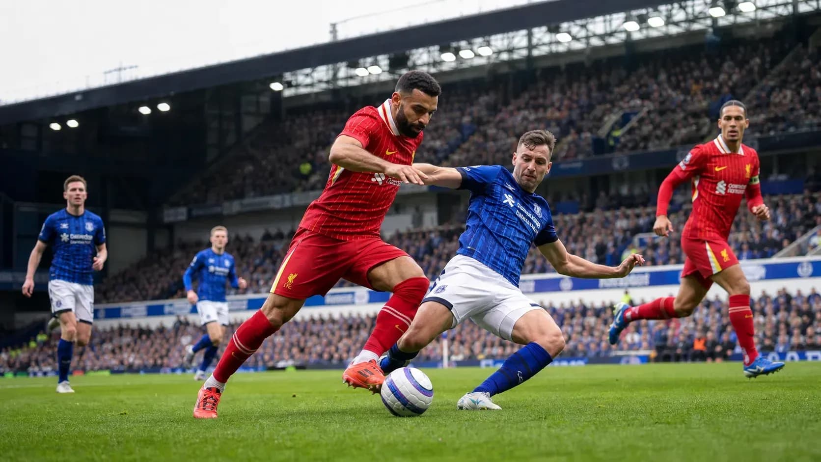 Liverpool and Everton players contesting for the ball