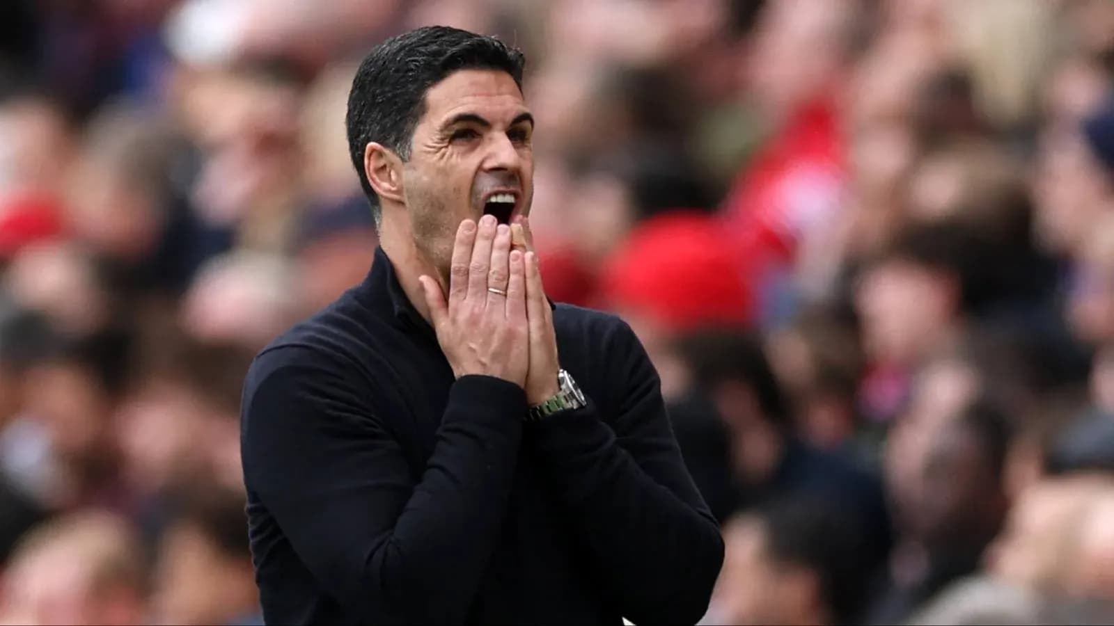 Manager gesturing on the sidelines during match