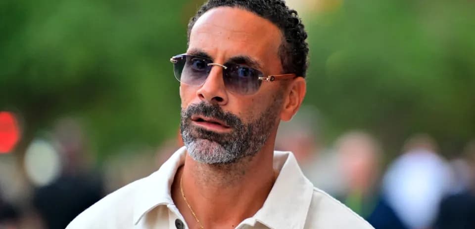 Man wearing sunglasses and a white shirt outdoors