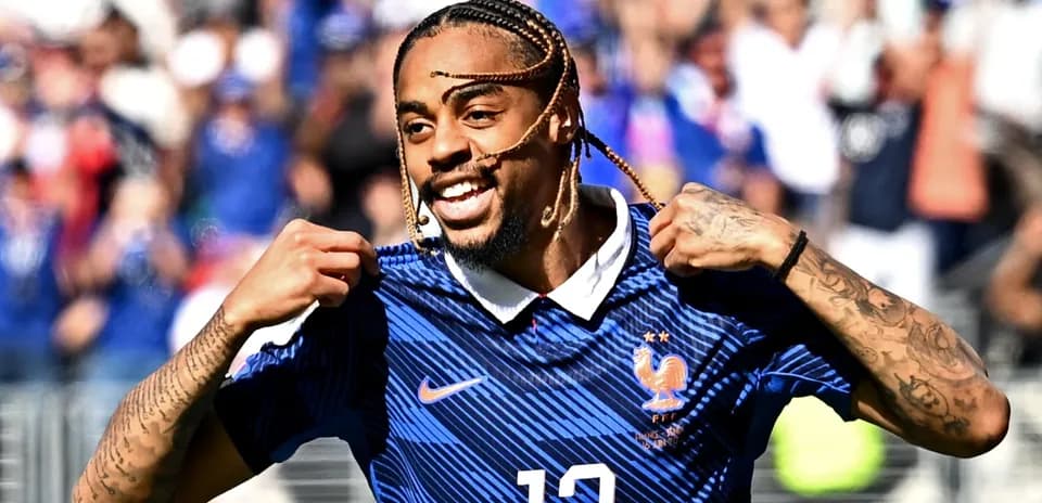 Player celebrating and pointing to jersey during match