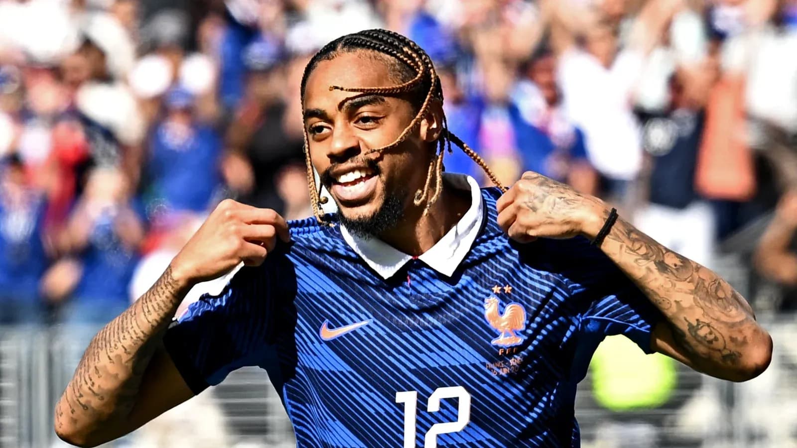Player celebrating and pointing to jersey during match
