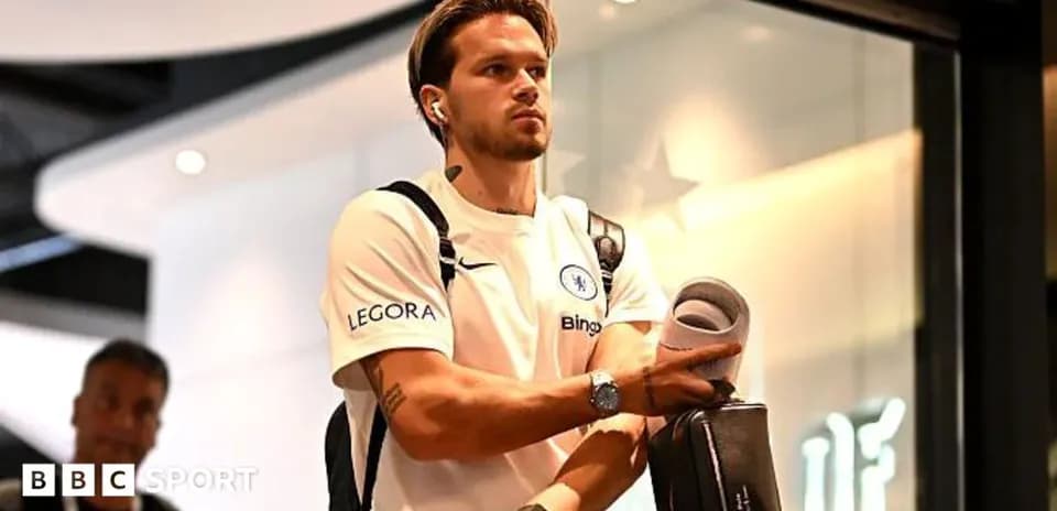 Player entering venue wearing Chelsea training gear