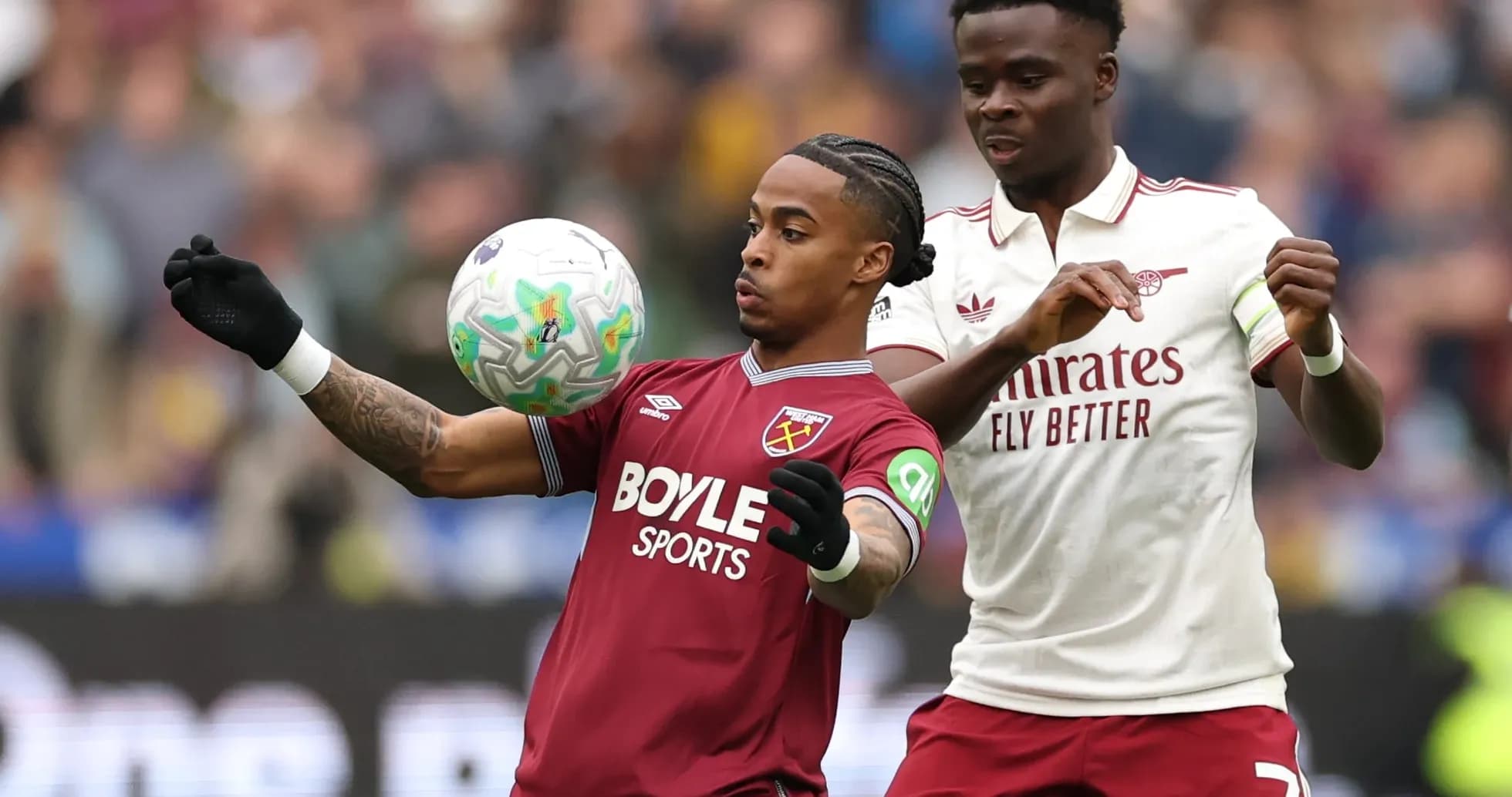 West Ham and Arsenal players competing for the ball