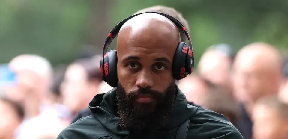 Player wearing headphones walking through crowd