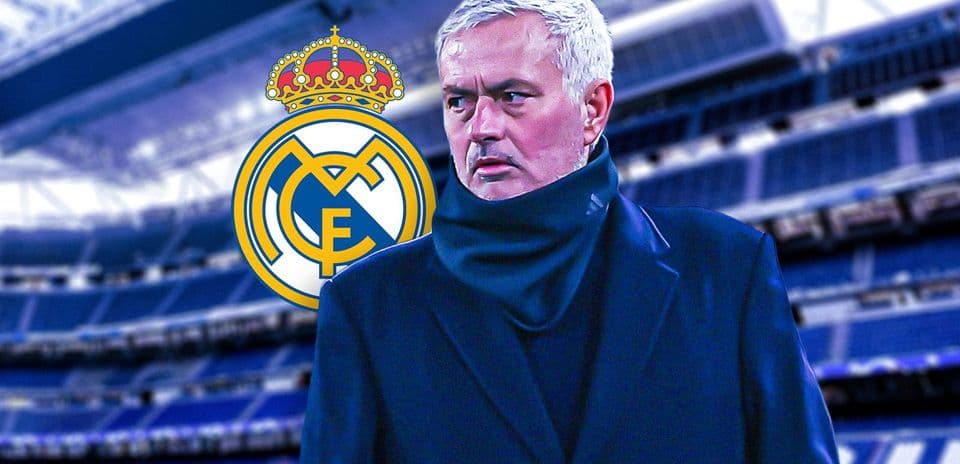Manager standing in front of Real Madrid logo