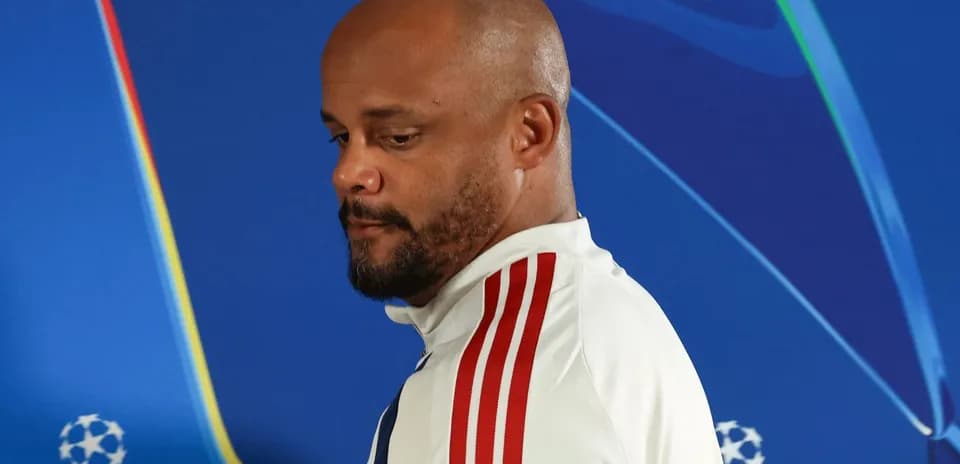 Manager walking past UEFA Champions League backdrop