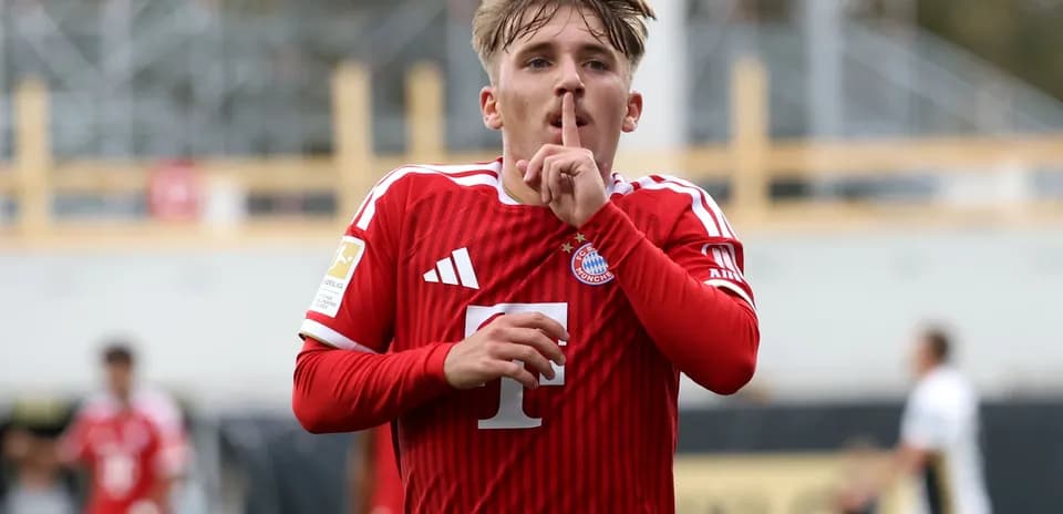 Player celebrating goal with finger on lips