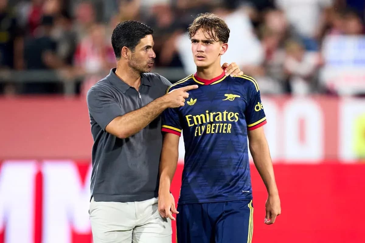 Manager speaking to player on the pitch