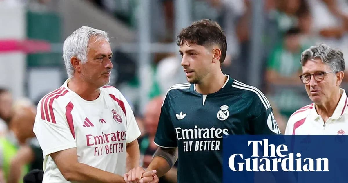 Manager and player shaking hands on pitch