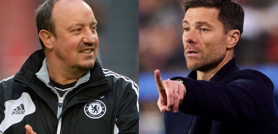 Two football managers on the sidelines during a match