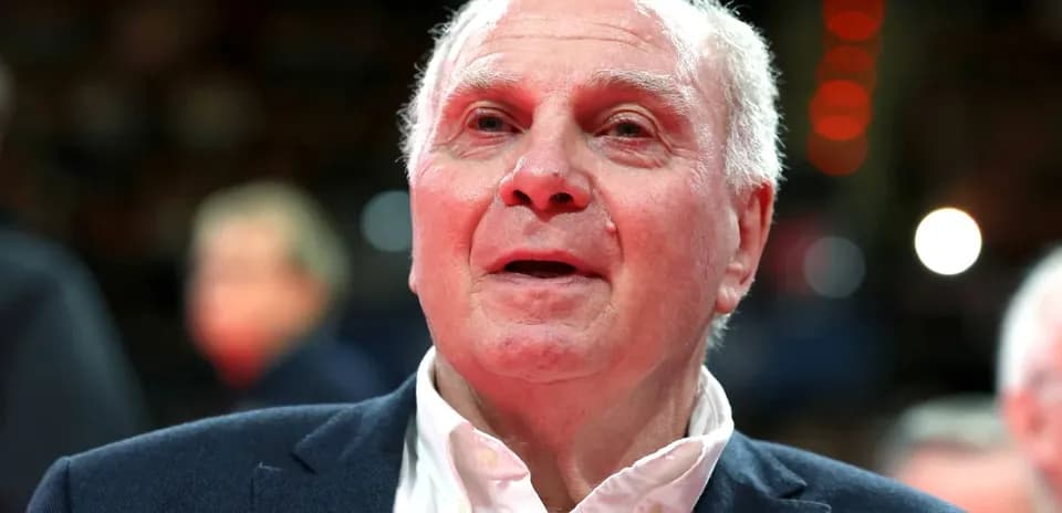 Elderly man in suit at sports event
