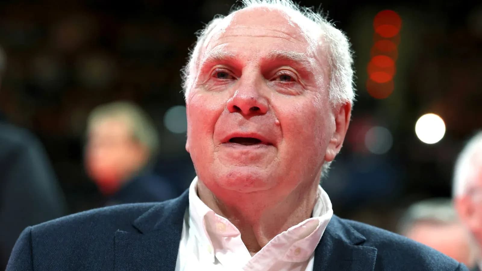 Elderly man in suit at sports event