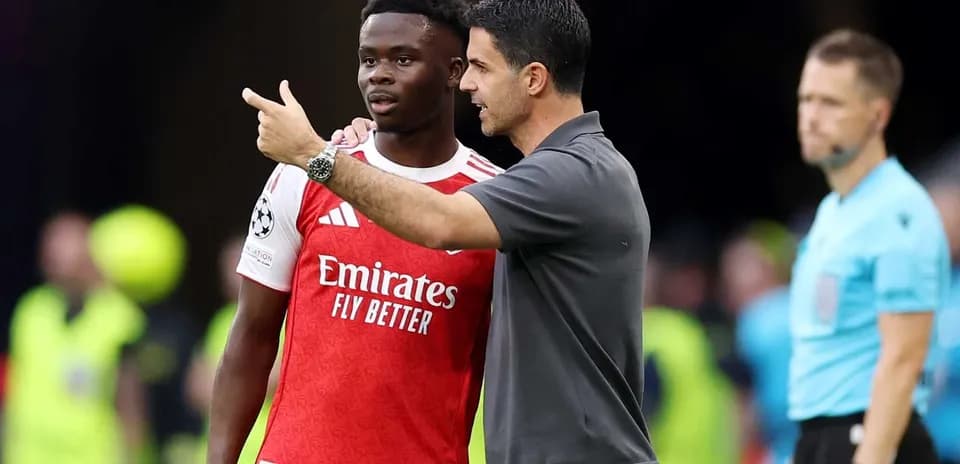 Manager discussing tactics with player during match