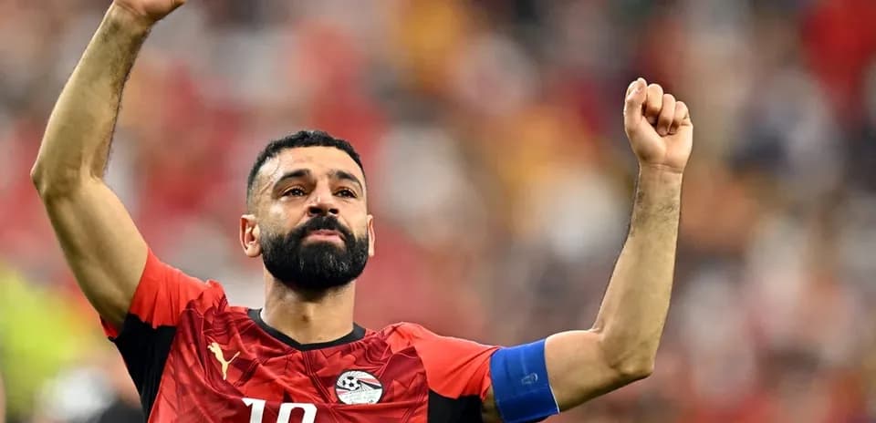 Player celebrating with raised arms in Egypt jersey