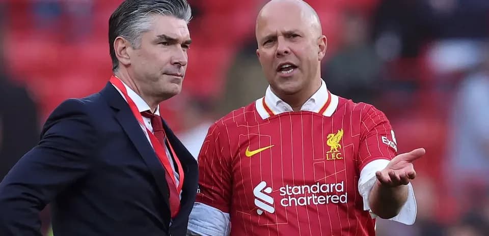 Two men talking in Liverpool FC jerseys