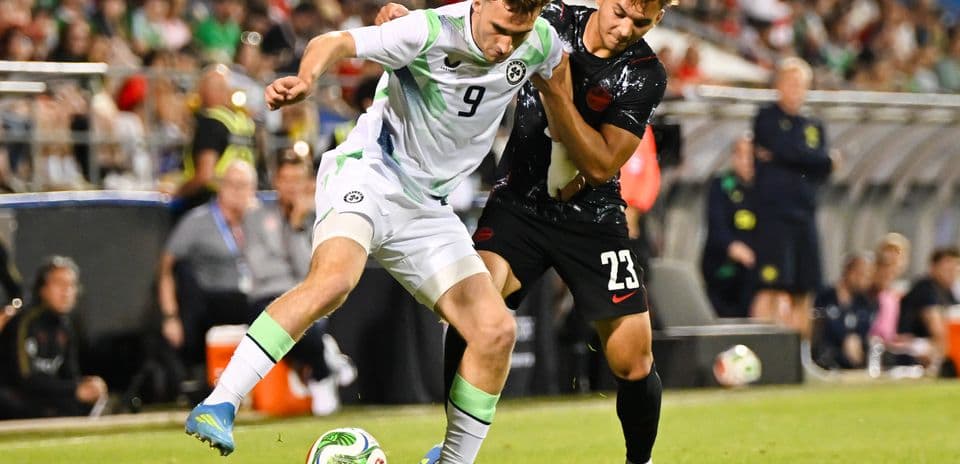 Two players competing for the ball during soccer match
