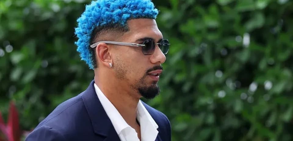 Man with blue hair wearing sunglasses and suit