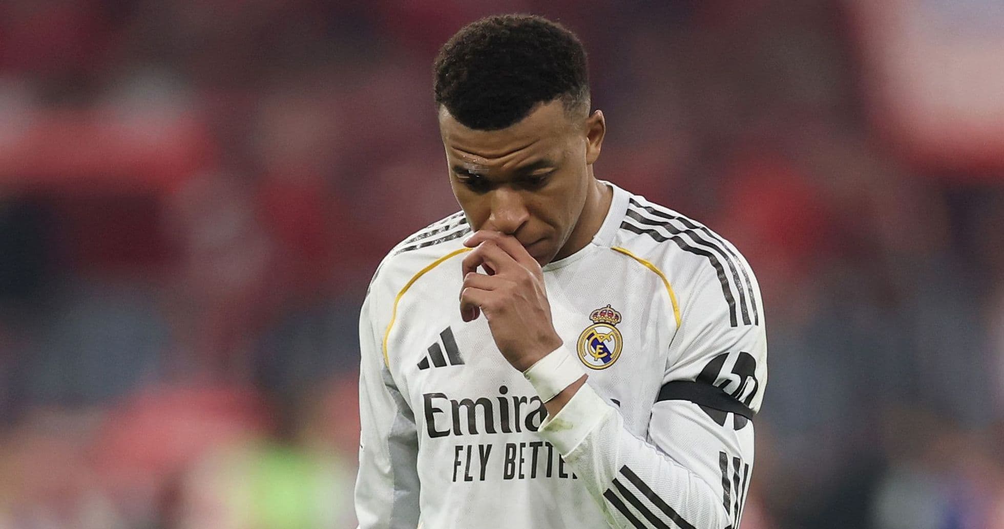 Player in Real Madrid kit walking with head down