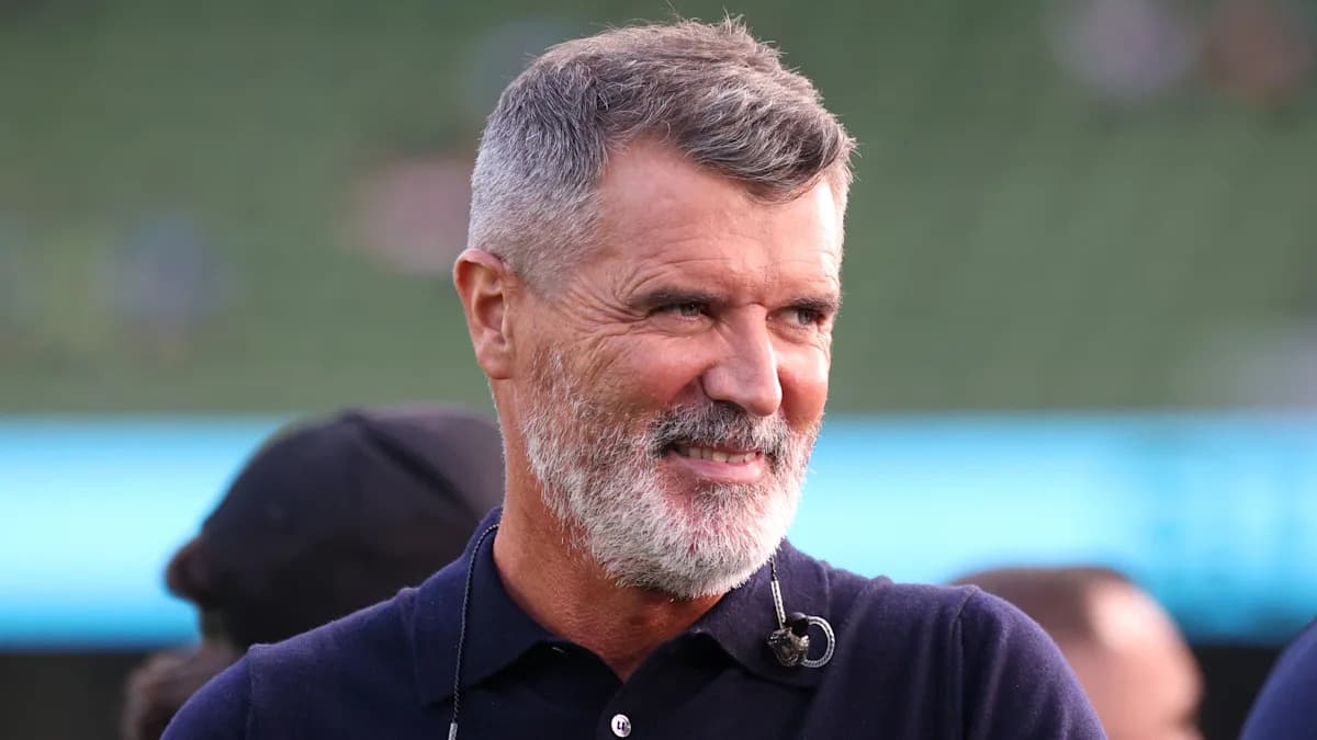 Man smiling in a stadium setting