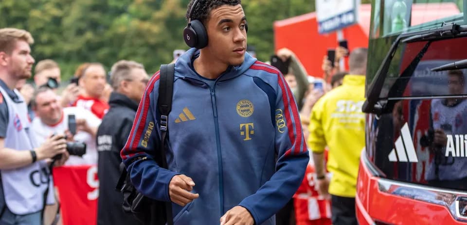 Player arriving at stadium wearing headphones
