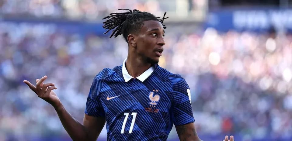 Football player in blue jersey gesturing during match