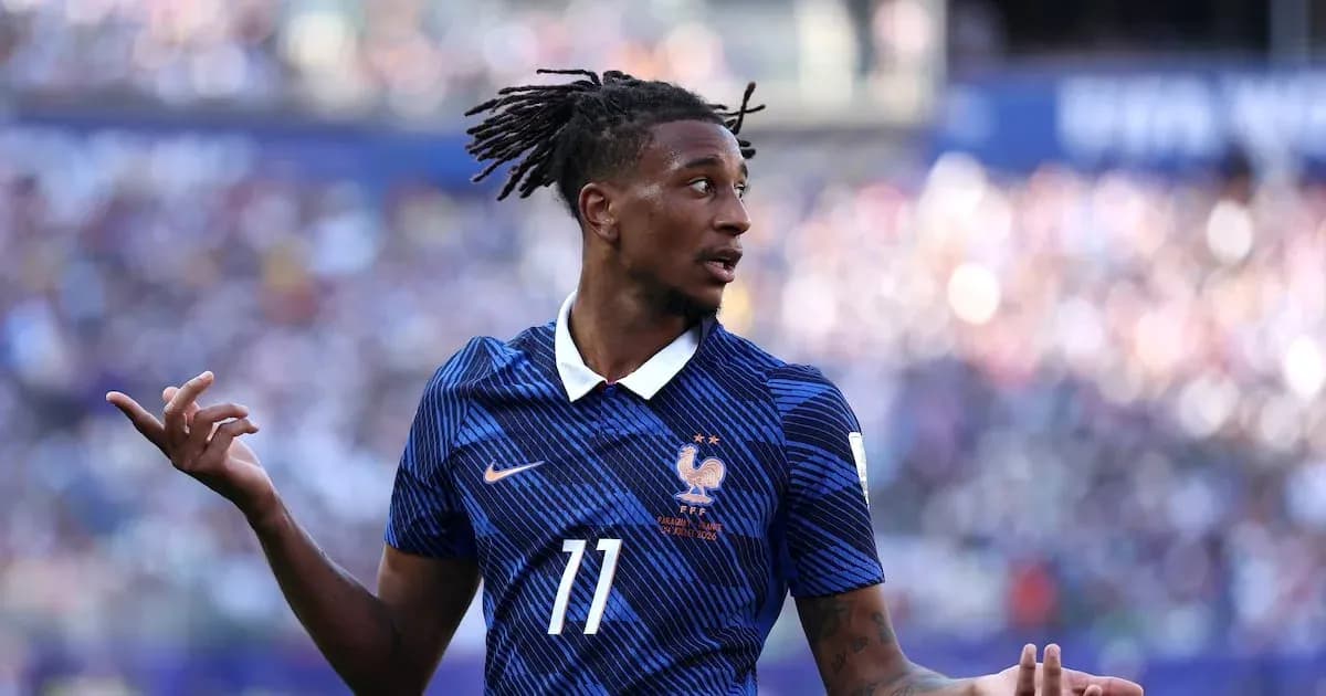 Football player in blue jersey gesturing during match