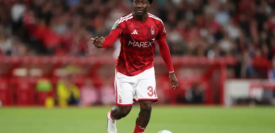 Player in red kit running with the ball