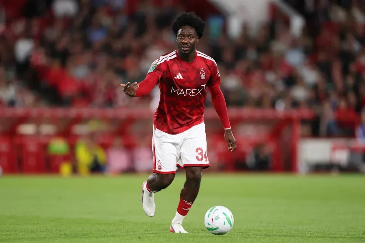 Player in red kit running with the ball