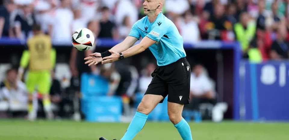 Referee throwing the ball during a match
